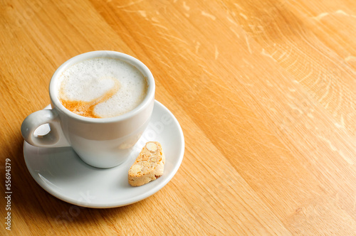 Photo: cappuccino cup on wooden table cappuccino cup on wooden table