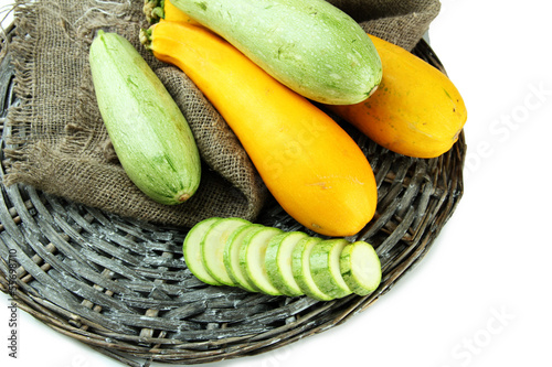 Photo: Sliced and whole raw zucchini, isolated on white Sliced and whole raw zucchini, isolated on white