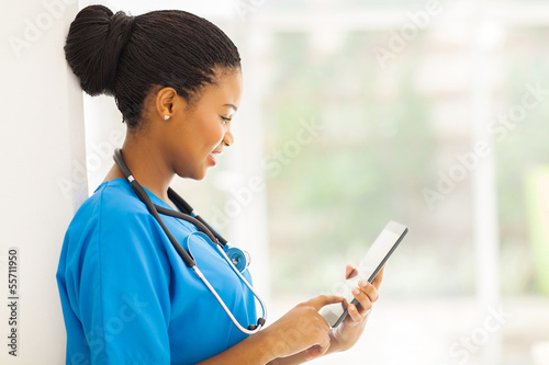 Photo: young african american medical worker using tablet computer young african american medical worker using tablet computer