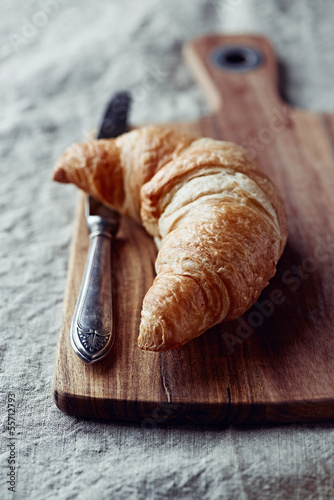 Photo: Croissant on a wooden kitchen board Croissant on a wooden kitchen board