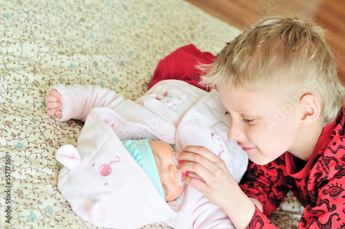 Photo: loving brother with newborn sister loving brother with newborn sister