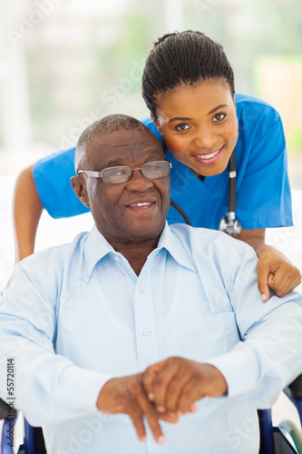 Photo: elderly african american man and caring young caregiver elderly african american man and caring young caregiver