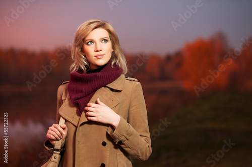 Photo: Young blond woman against an autumn nature background Young blond woman against an autumn nature background
