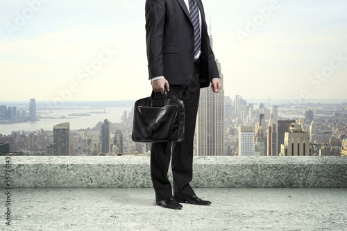 Photo: businessman standing on roof businessman standing on roof