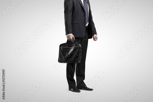 Photo: man standing with briefcase man standing with briefcase