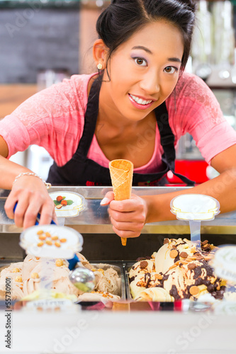 Photo: Female seller in Parlor with ice cream cone Female seller in Parlor with ice cream cone