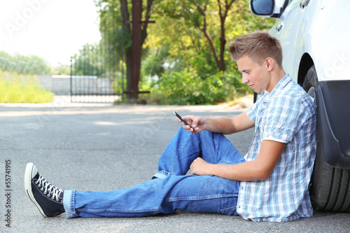 Photo: Man calling repair service after car breakdown Man calling repair service after car breakdown