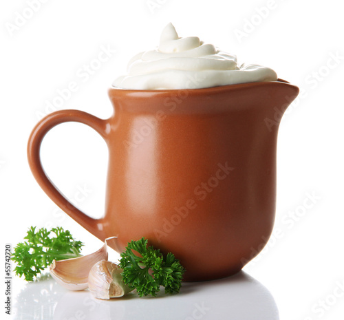 Photo: Sour cream in pitcher isolated on white Sour cream in pitcher isolated on white