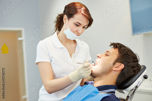 Photo: Man with toothache at dentist Man with toothache at dentist