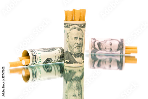 Photo: money (U.S. dollars) and a cigarette on a white background money (U.S. dollars) and a cigarette on a white background