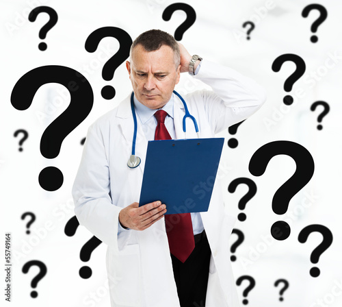 Photo: Doctor scratching his head Doctor scratching his head
