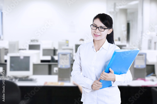 Photo: Attractive female worker at office Attractive female worker at office