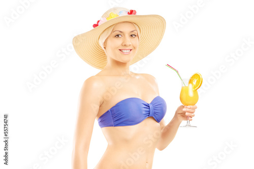 Photo: Woman in bikini holding a cocktail Woman in bikini holding a cocktail