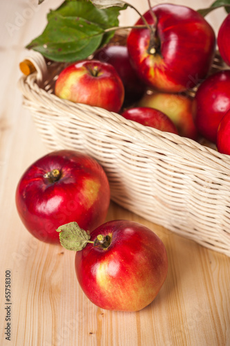 Photo: Ripe red apples in a basket on the table Ripe red apples in a basket on the table