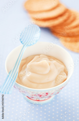 Photo: Caramel cream in a ceramic bowl and waffles, selective focus Caramel cream in a ceramic bowl and waffles, selective focus