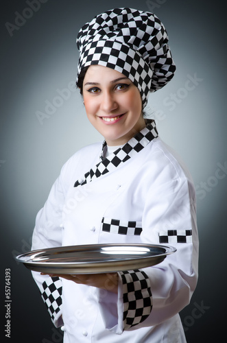 Photo: Pretty cook with kitchen utensils Pretty cook with kitchen utensils