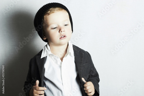 Photo: fashionable little boy in cap.stylish kid. fashion children. fashionable little boy in cap.stylish kid. fashion children.