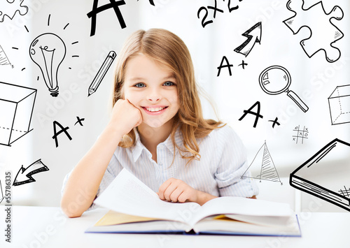 Photo: little student girl studying at school little student girl studying at school