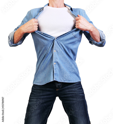 Photo: Superhero. Image of young man tearing his shirt off isolated on Superhero. Image of young man tearing his shirt off isolated on