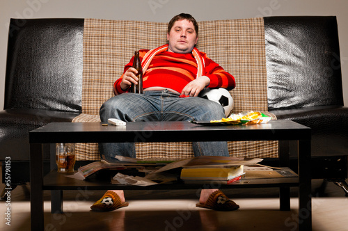 Photo: soccer fan on sofa soccer fan on sofa