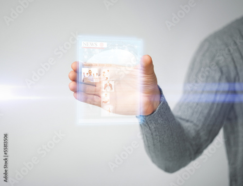 Photo: man showing tablet pc with news man showing tablet pc with news