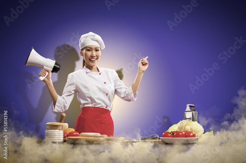 Photo: Asian female cook holding megaphone Asian female cook holding megaphone