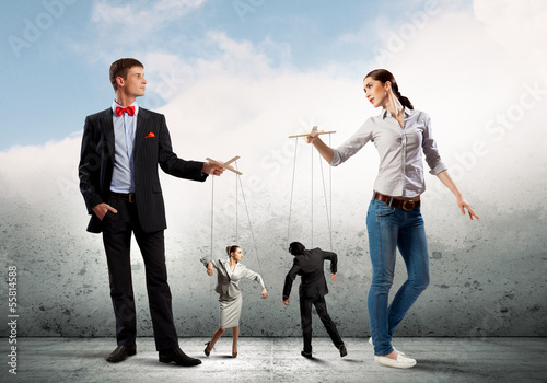 Photo: Businesspeople with marionettes Businesspeople with marionettes