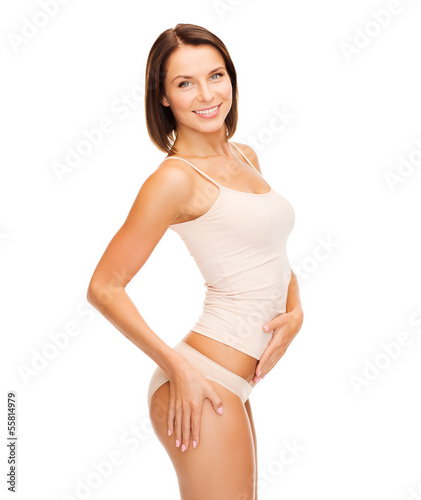 Photo: woman in cotton underwear showing slimming concept woman in cotton underwear showing slimming concept