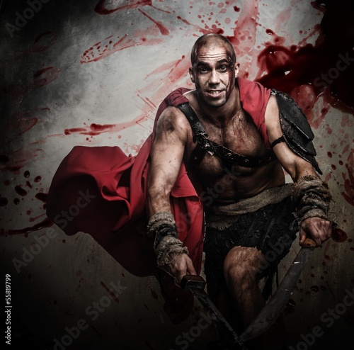 Photo: Wounded gladiator attacking with two swords Wounded gladiator attacking with two swords