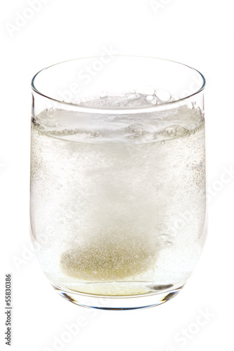 Photo: Fizzing pill tossed into the glass, dissolving Fizzing pill tossed into the glass, dissolving