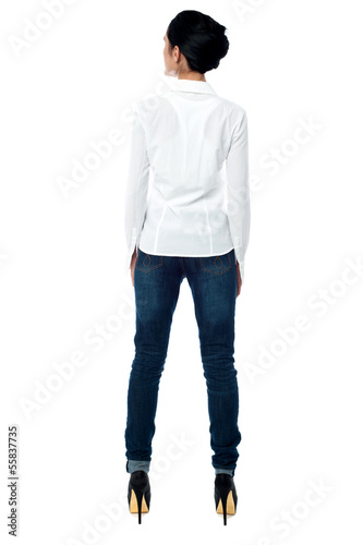 Photo: Young woman in casuals, rear view Young woman in casuals, rear view