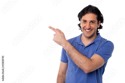 Photo: Handsome man pointing at something Handsome man pointing at something