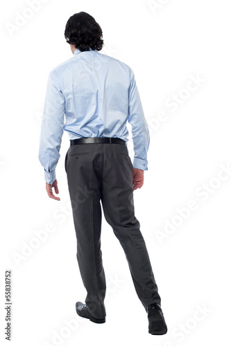 Photo: Young businessman in walking posture Young businessman in walking posture