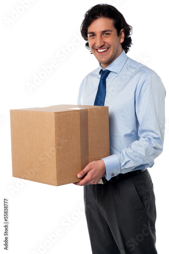Photo: Male executive holding cardboard box Male executive holding cardboard box