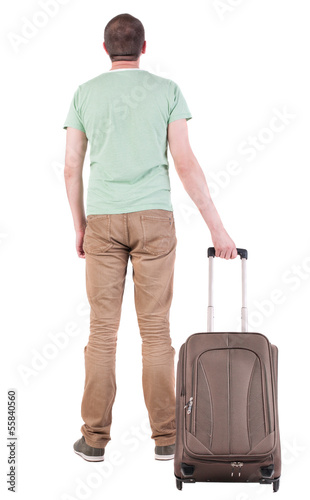 Photo: Back view of man with suitcase looking up Back view of man with suitcase looking up