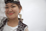 Photo: Portrait of young smiling woman in traditional clothing from Kazakhstan, studio shot Portrait of young smiling woman in traditional clothing from Kazakhstan, studio shot