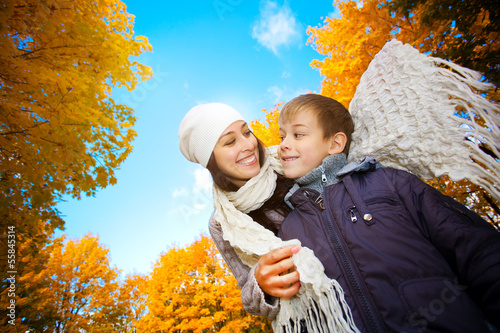 Photo: Mom with son in a yellow autumn park Mom with son in a yellow autumn park