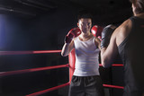 Photo: Over the shoulder view of two male boxers getting ready to box in the boxing ring in Beijing, China Over the shoulder view of two male boxers getting ready to box in the boxing ring in Beijing, China