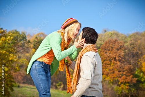 Photo: Sweet young couple have a fun in park. Sweet young couple have a fun in park.