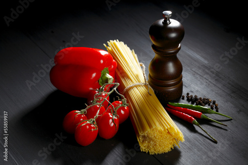 Photo: Pasta ingredients on black table Pasta ingredients on black table