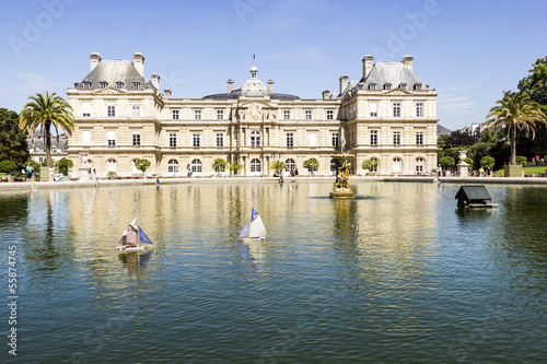 Photo: Traditional small wooden sailing boat in the pond of park Jardin Traditional small wooden sailing boat in the pond of park Jardin