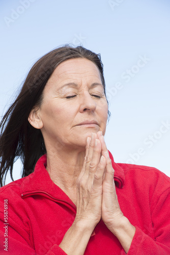Photo: Praying woman relaxed and closed eyes Praying woman relaxed and closed eyes