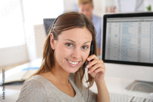 Photo: Beautiful smiling teleoperator with headset on Beautiful smiling teleoperator with headset on