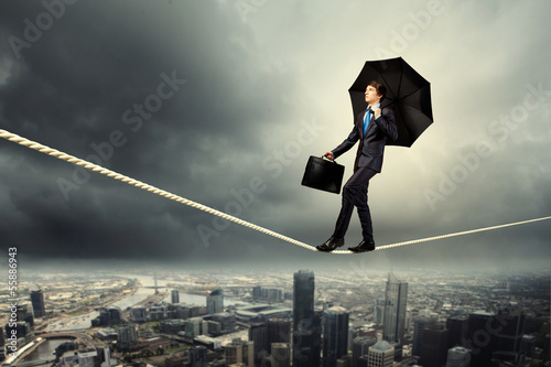 Photo: Businessman balancing on rope Businessman balancing on rope