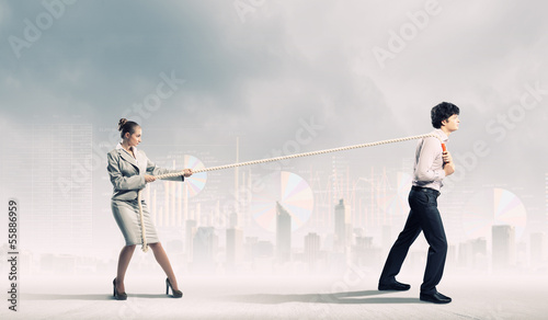 Photo: Three business people pulling rope Three business people pulling rope