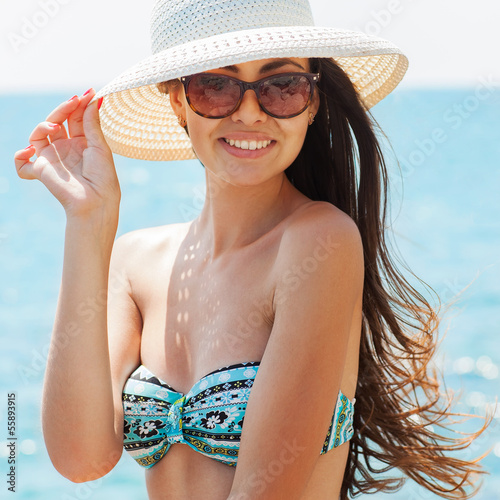 Photo: Young, beautiful, sporty and sexy woman relaxing on the beach Young, beautiful, sporty and sexy woman relaxing on the beach