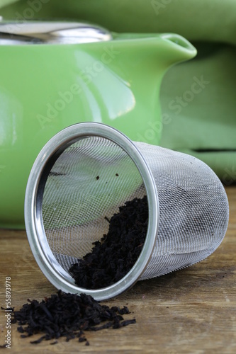 Photo: granulated black tea in a metal cup on a wooden table granulated black tea in a metal cup on a wooden table