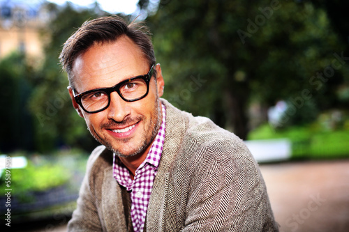 Photo: Trendy handsome man with eyeglasses in the street Trendy handsome man with eyeglasses in the street