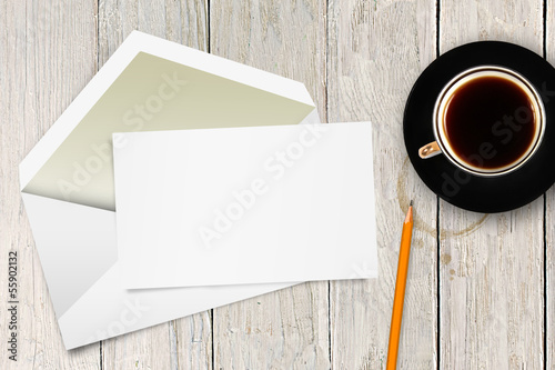 Photo: blank letter with envelope and coffee cup on the table blank letter with envelope and coffee cup on the table