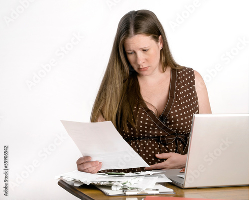 Photo: Pregnant Worried Young Woman Reading Bills at Laptop Computer Pregnant Worried Young Woman Reading Bills at Laptop Computer